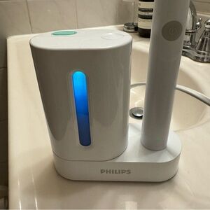 Sonicare brush with UV disinfectant/charger and brush head